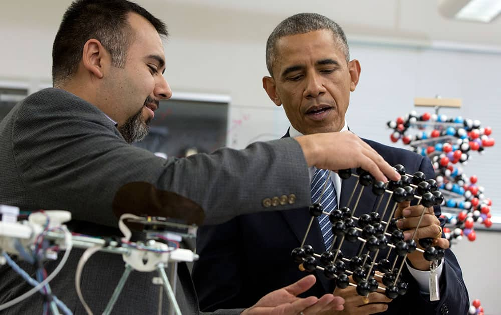 President Barack Obama talks with Professor Dave Estrada as he tours the new Product Development Lab in Boise State University’s Micron Engineering Center, in Boise , Idaho, before speaking about the themes in his State of the Union address. 