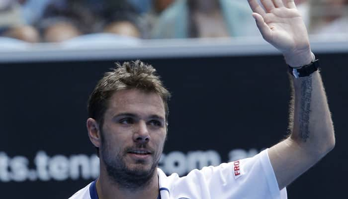 Defending champion Stan Wawrinka battles into third round 