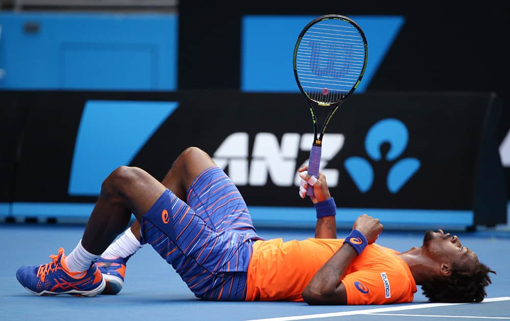 Gael Monfils of France lays on the court after he fell during his second round match against Jerzy Janowicz of Poland at the Australian Open tennis championship in Melbourne, Australia.