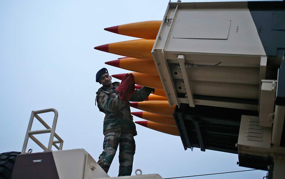 An Indian soldier cleans missiles that will form part of Republic Day parade during a practice session in New Delhi.