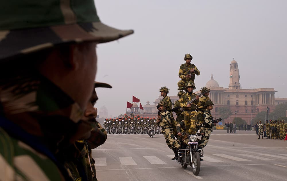 Soldiers make a formation on a motorcycle as they rehearse ahead of Republic Day parade in New Delhi.