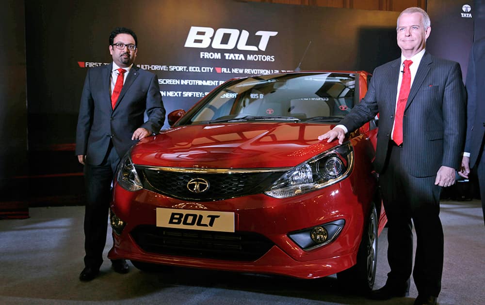 Tata Motors head of Advanced and Product Engineering Timothy Leverton, right, and head of Design Pratap Bose pose for photos during the unveiling of Bolt, a premium hatchback, in Kolkata.