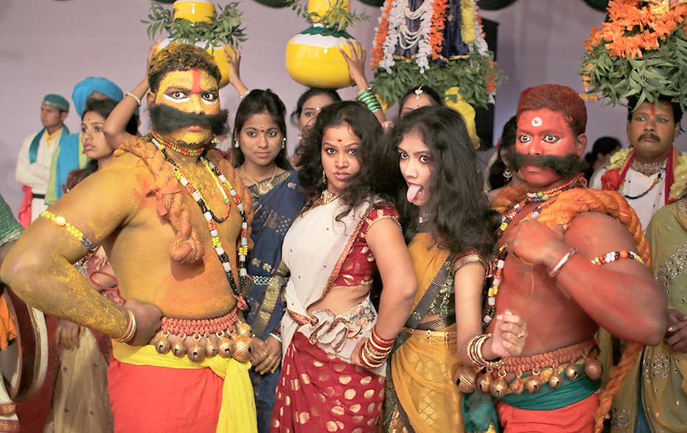 Artists from the state of Telangana react to the camera as they wait for their turn to perform during a media preview displaying a glimpse of culture of different parts of India, in New Delhi.