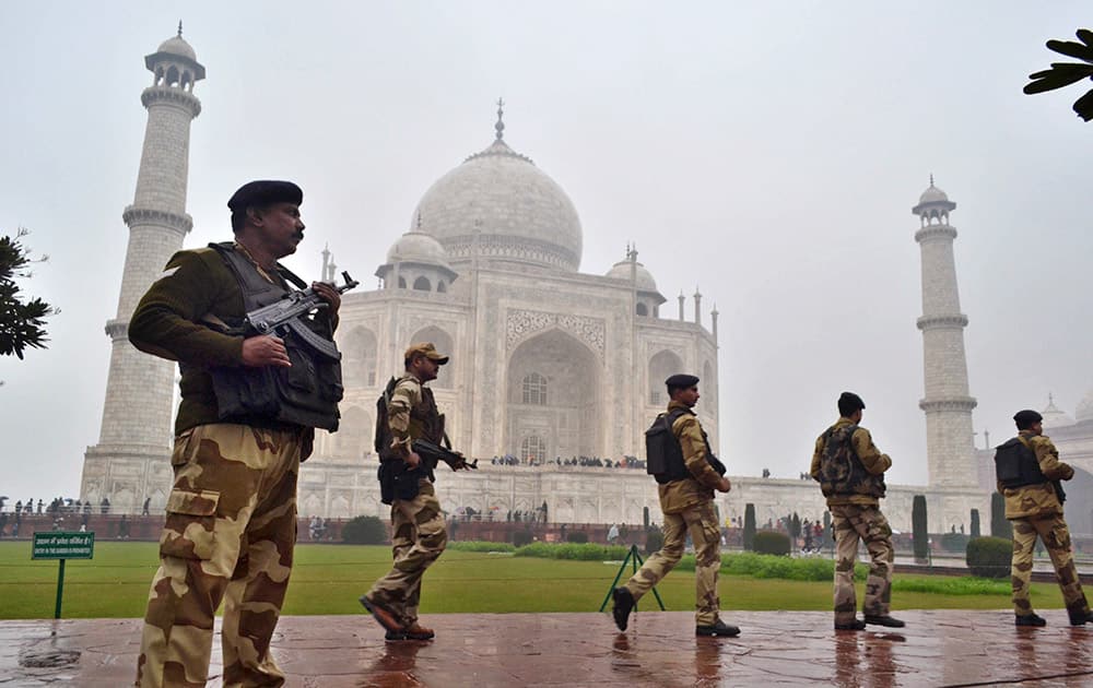 Central Industrial Security Force (CISF) personnel keep a watch on the surroundings at the Taj Mahal before US President Barack Obama’s visit in Agra.