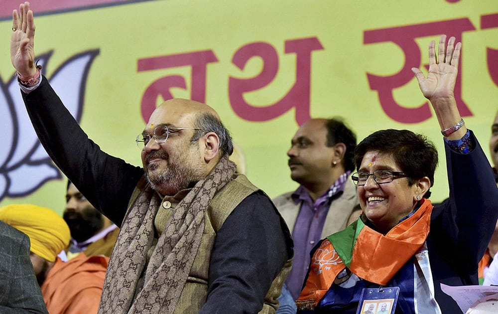 BJP President Amit Shah and partys Delhi Chief Ministerial candidate Kiran Bedi waves to partys booth in-charges at a rally in New Delhi.