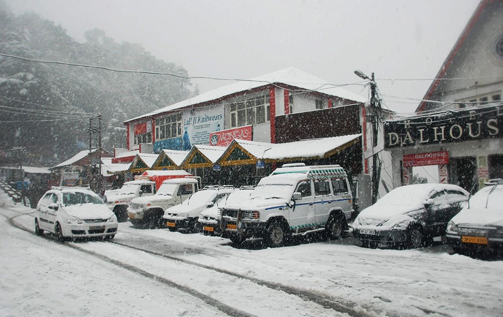 Vechile covered with snow during snowfall at Dalhousie.