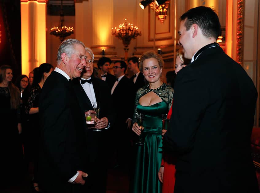 Britain's Prince Charles, meets Australian singers, Soprano and cellist Taryn Fiebig, 2nd left, Soprano Kiandra Howarth, partially hidden, and Tenor Samuel Sakker, right, after a concert at Buckingham Palace in London.