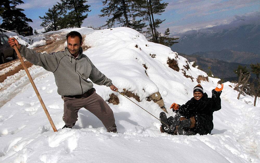 Tourists enjoying first snow fall at Nathatop about 110 KM from Jammu.