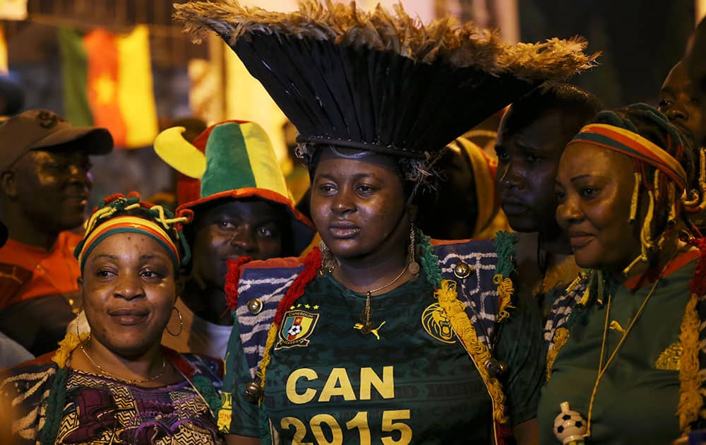 Cameroon soccer supporters pose for photographs on the street ahead of Cameroon soccer national team Group D Match on Saturday against Guinea at Estadio De Malabo in Malabo, Equatorial Guinea.