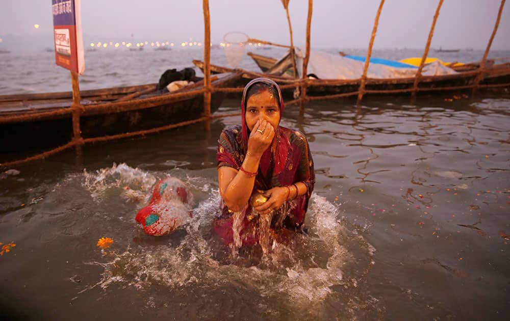A Hindu devotees takes a dip at the Sangam, on Basant Panchami, the fourth auspicious date of bathing, during the annual month-long Hindu religious fair of Magh Mela in Allahabad.