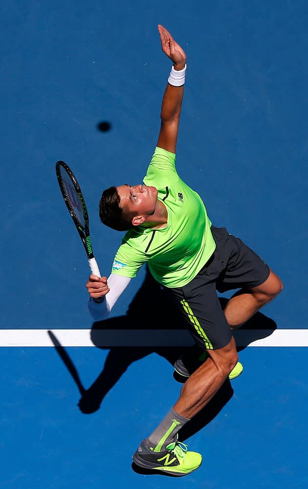 Milos Raonic of Canada serves to Benjamin Becker of Germany during their third round match at the Australian Open tennis championship in Melbourne, Australia.