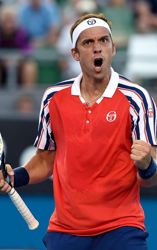 Gilles Muller of Luxembourg celebrates a point won during his third round match against John Isner of the U.S. at the Australian Open tennis championship in Melbourne, Australia.