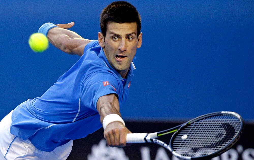 Novak Djokovic of Serbia makes a backhand return to Fernando Verdasco of Spain during their third round match at the Australian Open tennis championship in Melbourne, Australia.