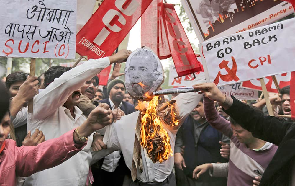 Members of various Left Front political parties set an effigy with an image of US President Barack Obama on fire during a protest march against his visit to India, in New Delhi.