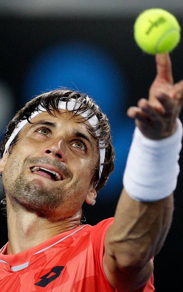 David Ferrer of Spain serves to Gilles Simon of France during their third round match at the Australian Open tennis championship in Melbourne, Australia.