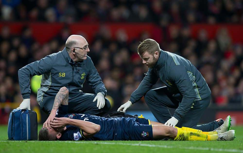 Southampton's Toby Alderweireld is treated on the pitch before being substituted injured during his team's during the English Premier League soccer match between Manchester United and Southampton at Old Trafford Stadium, Manchester, England.