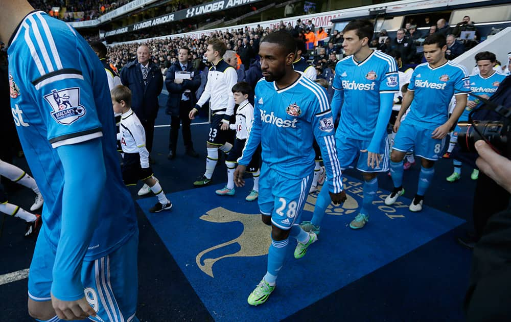 Sunderland's Jermain Defoe, center, walks out of the tunnel for the English Premier League soccer match between Tottenham Hotspur and Sunderland at White Heart Lane, London.