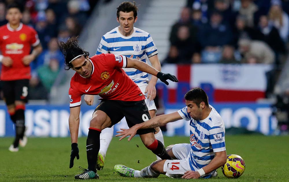 Queens Park Rangers' Esteban Granero, right, and Joey Barton, center back, compete for the ball with Manchester United's Radamel Falcao, left, during the English Premier League soccer match between QPR and Manchester United at Loftus Road stadium in London.