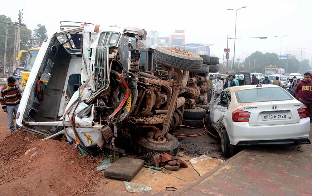 Scene of an accident where a speedy truck hit a car and overturned at Fazilpur Chowk in Gurgaon injuring all passengers.