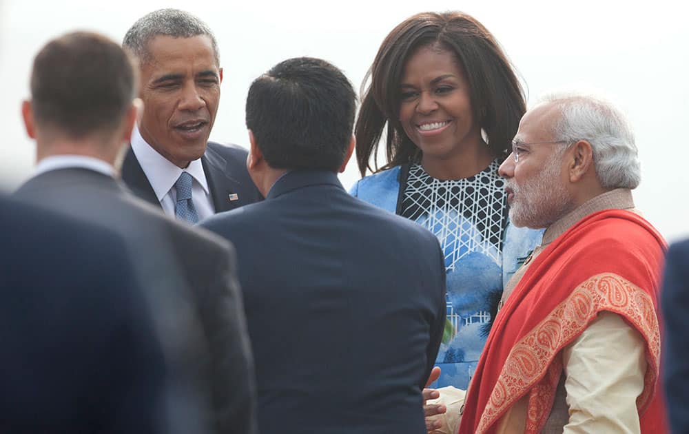 President Barack Obama and first lady Michelle Obama are greeted by Indian Prime Minister Narendra Modi, right, as they arrive at Air Force Station Palam, in Palam, India.