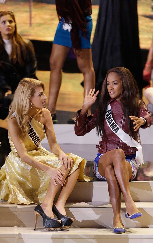 Miss Universe contestants Gabriela Ordonez, left, of Honduras, and Yomatsy Hazlewood of Panama chat during a break in rehearsals, at Florida International University in Miami.