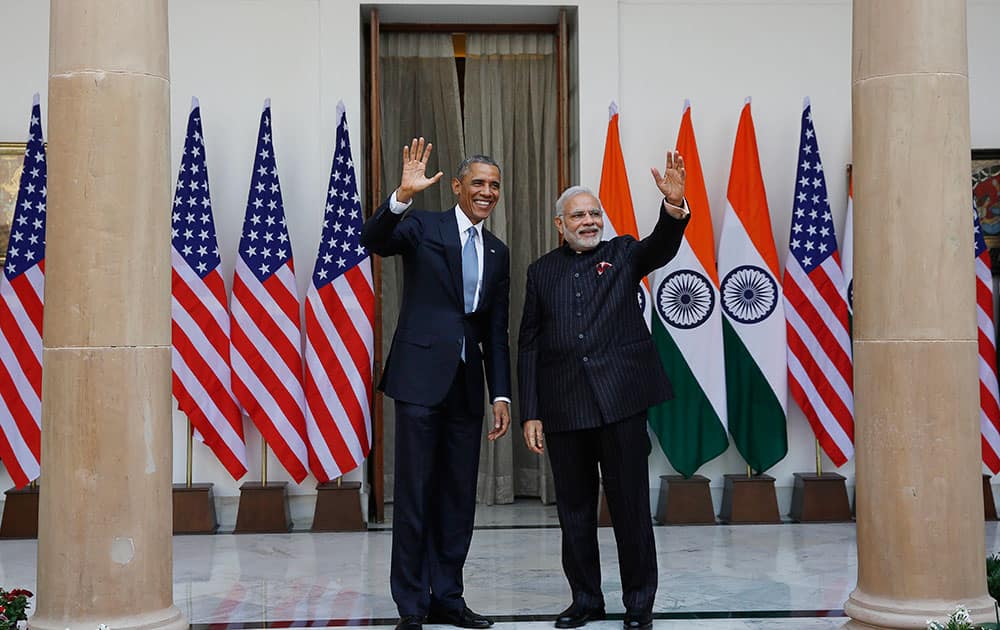 President Barack Obama and Indian Prime Minister Narendra Modi wave to the media before a meeting in New Delhi, India.