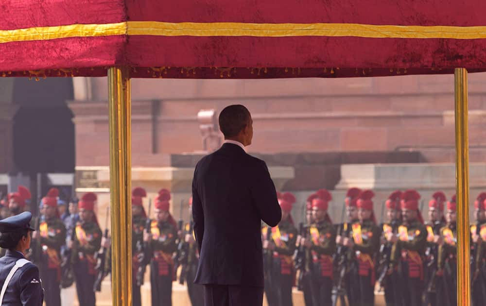 President Barack Obama stands for his country's national anthem during a ceremonial reception at the Indian Presidential Palace in New Delhi, India.
