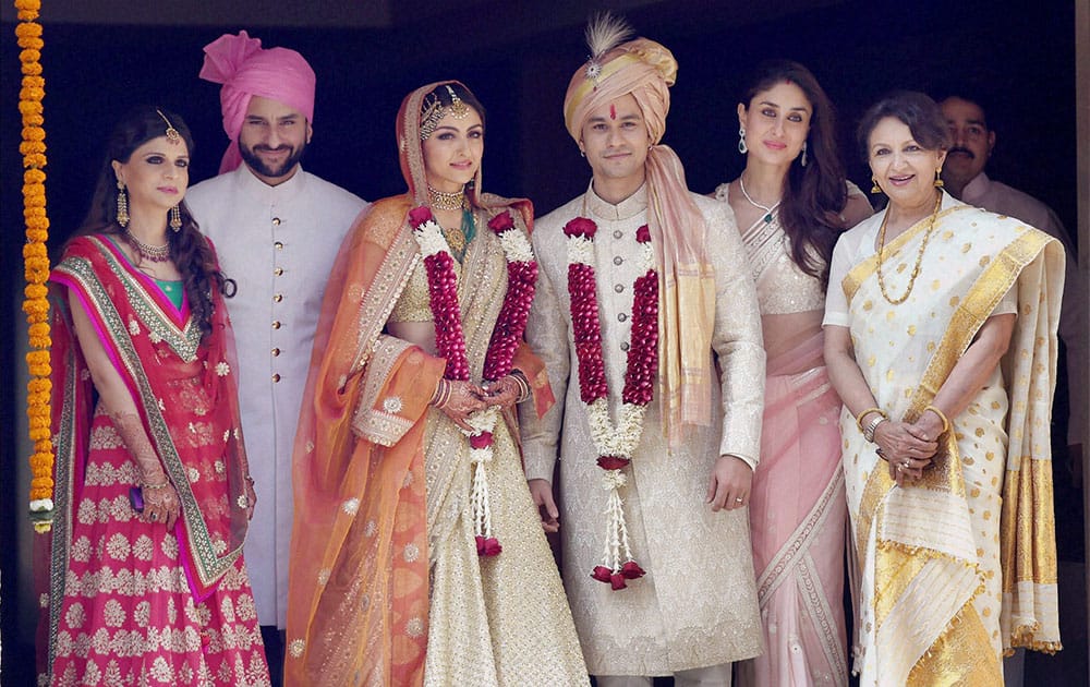 Newly wed couple Soha Ali Khan and Kunal Khemu along with family members (L to R) Sabah Ali Khan, Sharmila Tagore, Saif Ali Khan and Kareena Kapoor Khan stand for photo opportunity outside their residence in Mumbai.