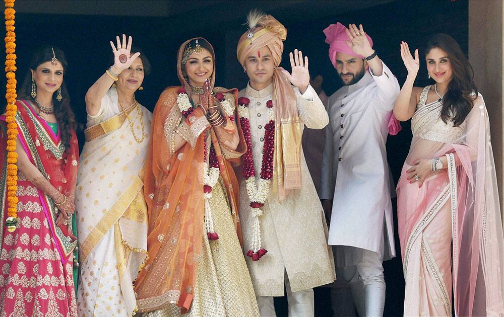 Newly wed couple Soha Ali Khan and Kunal Khemu along with family members Sabah Ali Khan, Sharmila Tagore, Saif Ali Khan and Kareena Kapoor Khan stand for photo opportunity outside their residence in Mumbai.