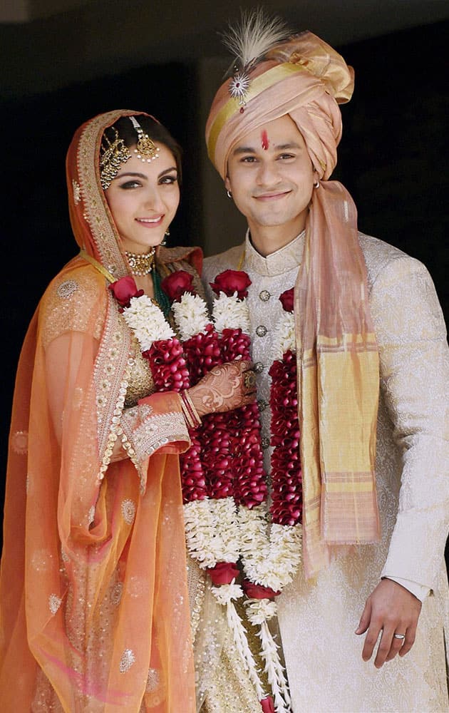 Newly-wed couple Soha Ali Khan and Kunal Khemu pose for photographs outside their residence in Mumbai on Sunday.