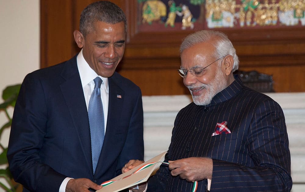 Indian Prime Minister Narendra Modi, right, gives U.S. President Barack Obama a copy of a 1950 telegram from Secretary of State Dean Acheson to the head of India's constitutional assembly, as they meet at the Hyderabad House in New Delhi.
