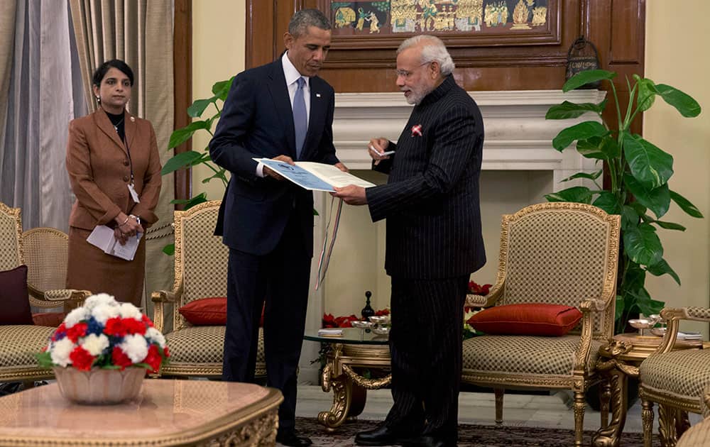 Indian Prime Minister Narendra Modi, right, gives U.S. President Barack Obama a copy of a 1950 telegram from Secretary of State Dean Acheson to the head of India's constitutional assembly, as they meet at the Hyderabad House in New Delhi, India.