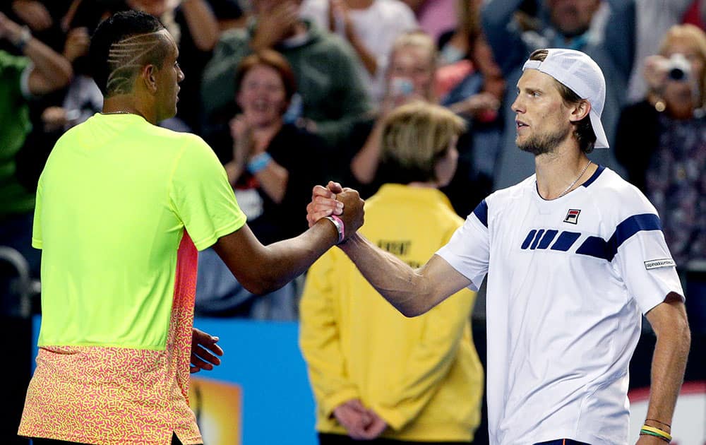 Nick Kyrgios of Australia, left, shakes hands with Andreas Seppi of Italy after winning their fourth round match at the Australian Open tennis championship in Melbourne, Australia, Sunday.