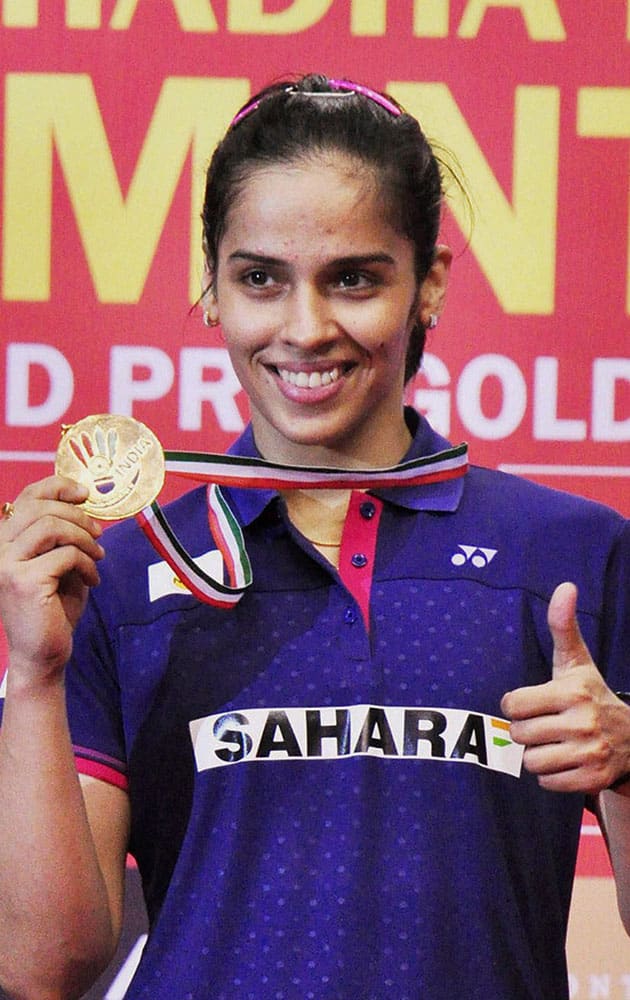 Saina Nehwal posing for photographs after winning the womens single tile of Syed Modi International Badminton Championship in Lucknow on Sunday. Nehwal beat Carolina Marin (Spain).
