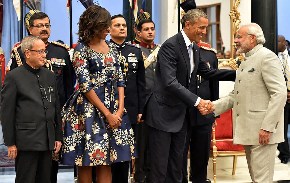 President Pranab Mukherjee and US First Lady Michelle Obama look on as US President Barack Obama shakes hands with Prime Minister Narendra Modi during a banquet hosted at the Rashtrapati Bhavan in New Delhi.