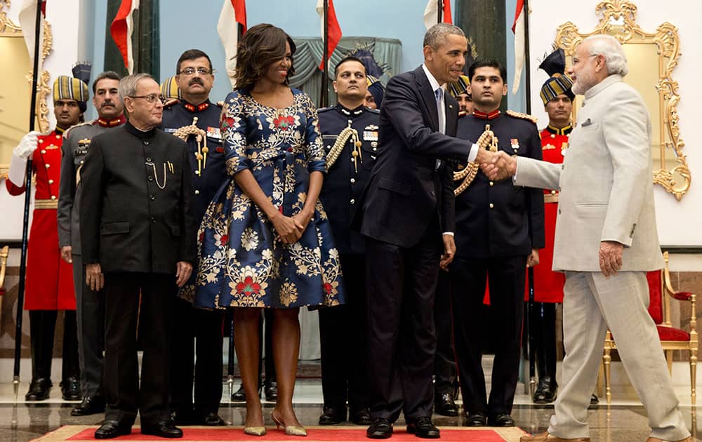 US President Barack Obama, shakes hands with Indian Prime Minister Narendra Modi, right, as first lady Michelle Obama and Indian President Pranab Mukherjee, left, look on during a receiving line before State Dinner at the Rashtrapati Bhavan, the presidential palace, in New Delhi.