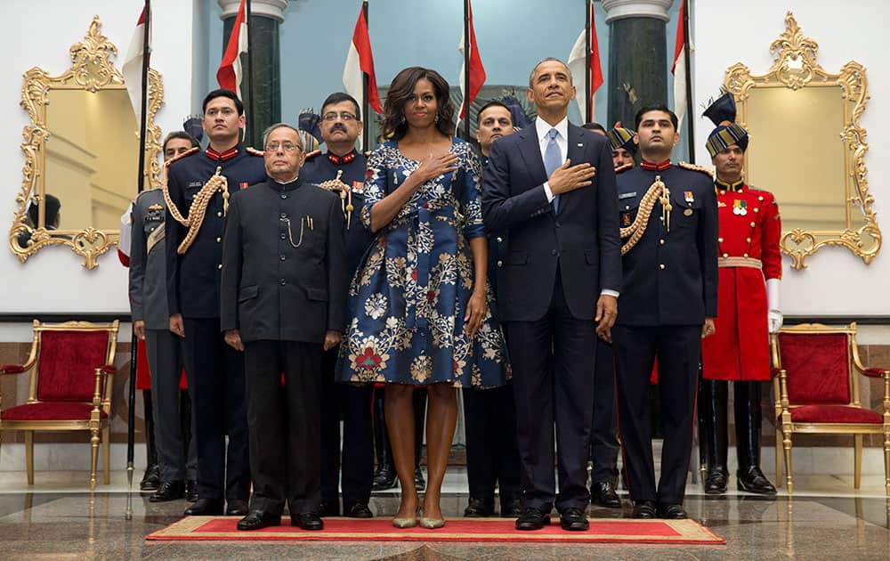 President Barack Obama, first lady Michelle Obama President Pranab Mukherjee, stand during the US National Anthem before a receiving line at the State Dinner at the Rashtrapati Bhavan, the presidential palace, in New Delhi.