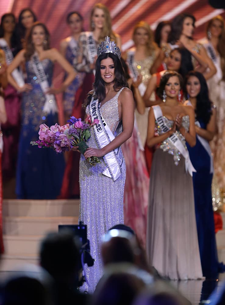 Miss Colombia Paulina Vega carries flowers after becoming Miss Universe at the Miss Universe pageant in Miami.