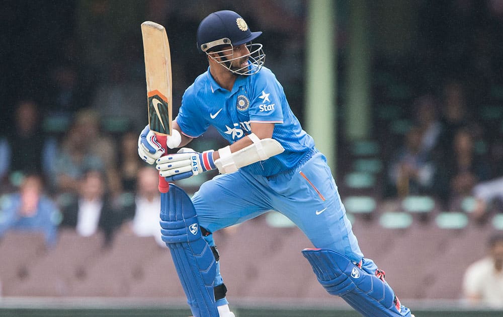 Ajinkya Rahane hits a ball to the boundary for 4 during their one day international cricket match in Sydney.