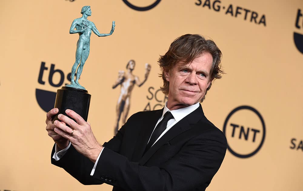 William H. Macy poses in the press room with the award for outstanding male actor in a comedy series for 'Shameless' at the 21st annual Screen Actors Guild Awards at the Shrine Auditorium, in Los Angeles.