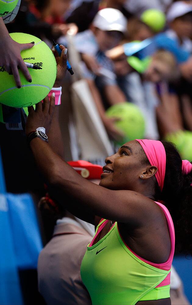 Serena Williams of the U.S. signs autographs for fans after defeating Garbine Muguruza of Spain in their fourth round match at the Australian Open tennis championship in Melbourne, Australia.