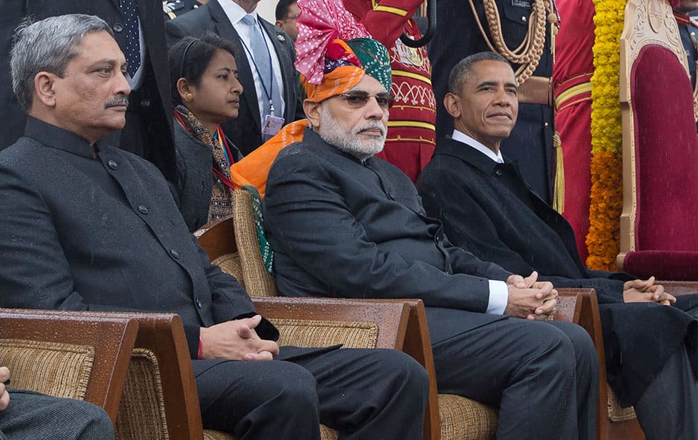 US President Barack Obama, sits with  Prime Minister Narendra Modi, center, during the Republic Day parade in New Delhi.