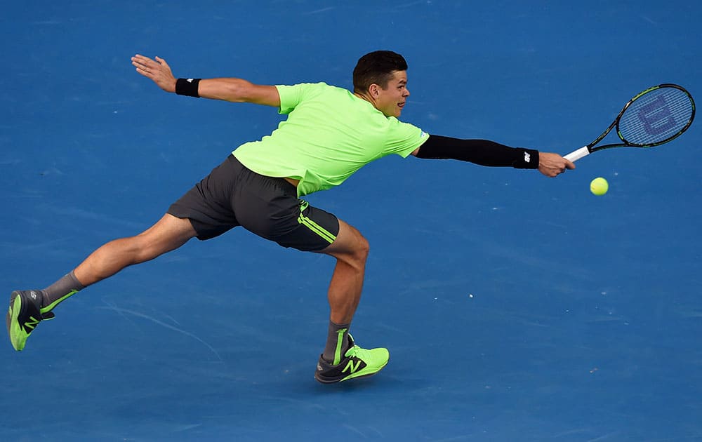 Milos Raonic of Canada stretches for a shot to Feliciano Lopez of Spain during their fourth round match at the Australian Open tennis championship in Melbourne, Australia, Monday.