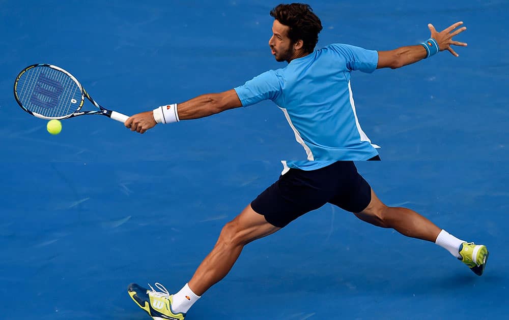 Feliciano Lopez of Spain stretches out for a shot to Milos Raonic of Canada during their fourth round match at the Australian Open tennis championship in Melbourne, Australia, Monday.