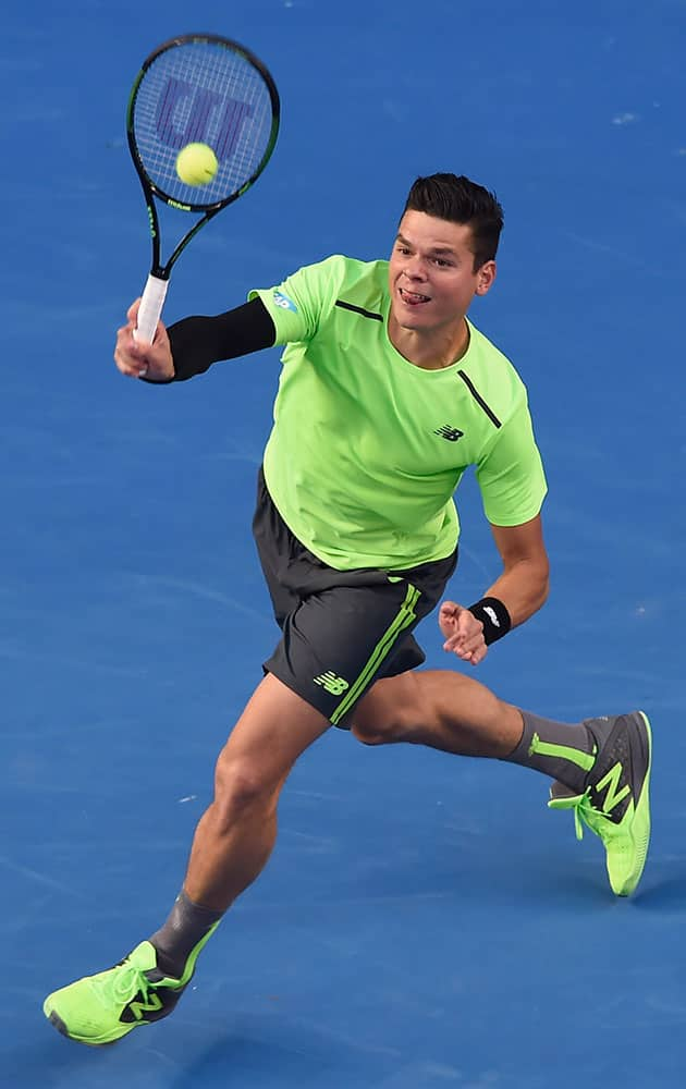 Milos Raonic of Canada plays a shot to Feliciano Lopez of Spain during their fourth round match at the Australian Open tennis championship in Melbourne, Australia, Monday.