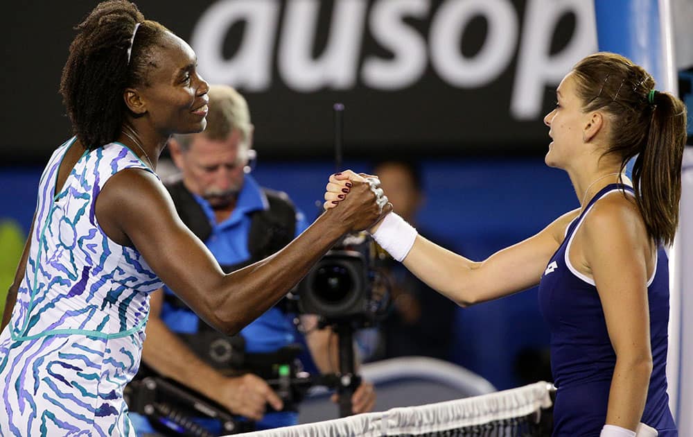 Venus Williams of the U.S., left, shakes hands with Agnieszka Radwanska of Poland after winning their fourth round match at the Australian Open tennis championship in Melbourne, Australia, Monday.