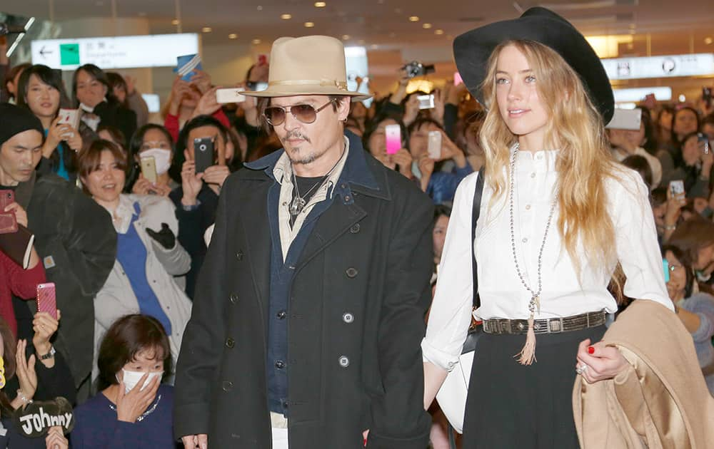 US actor Johnny Depp and his fiancee Amber Heard arrive at Haneda international airport in Tokyo for his latest film 'Mortdecai' promotion. 