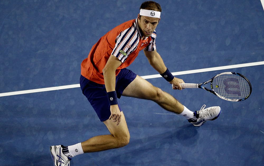 Gilles Muller of Luxembourg plays a shot to Novak Djokovic of Serbia during their fourth round match at the Australian Open tennis championship in Melbourne, Australia, Monday.