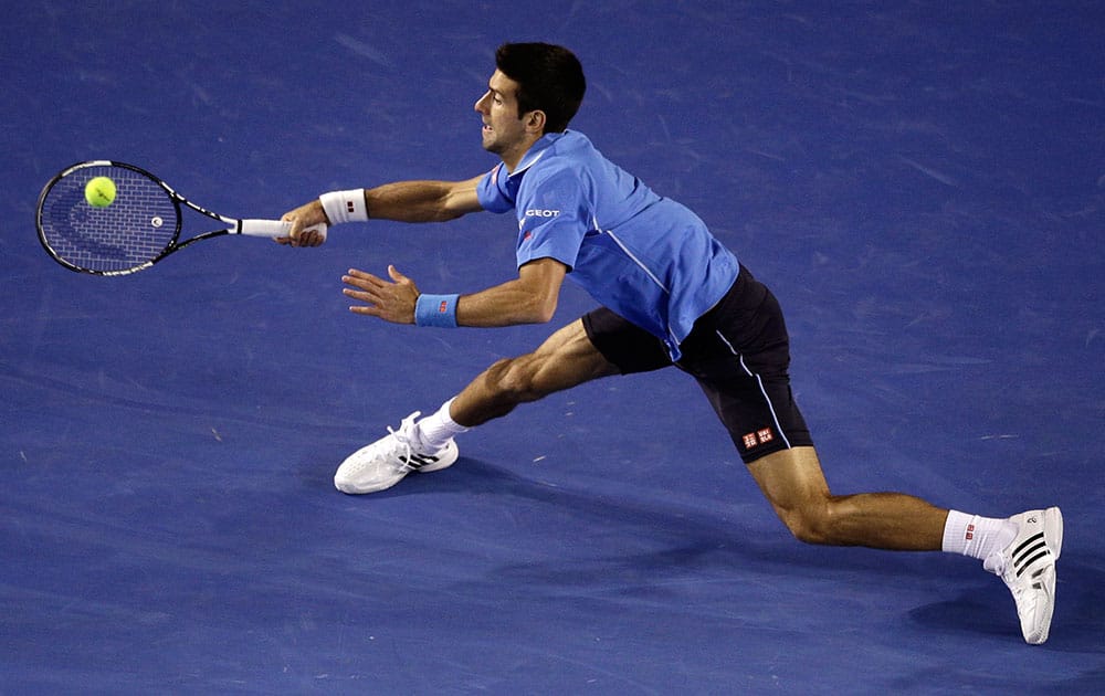 Novak Djokovic of Serbia stretches out for a return to Gilles Muller of Luxembourg during their fourth round match at the Australian Open tennis championship in Melbourne, Australia, Monday.