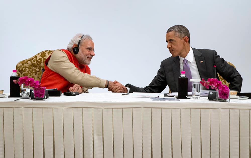 US President Barack Obama, shakes hands with Indian Prime Minister Narendra Modi as they participate in a CEO roundtable discussion at the The Taj Mahal Hotel in New Delhi.